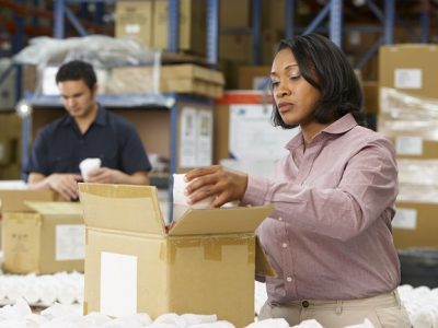 Manager Checking Goods On Production Line